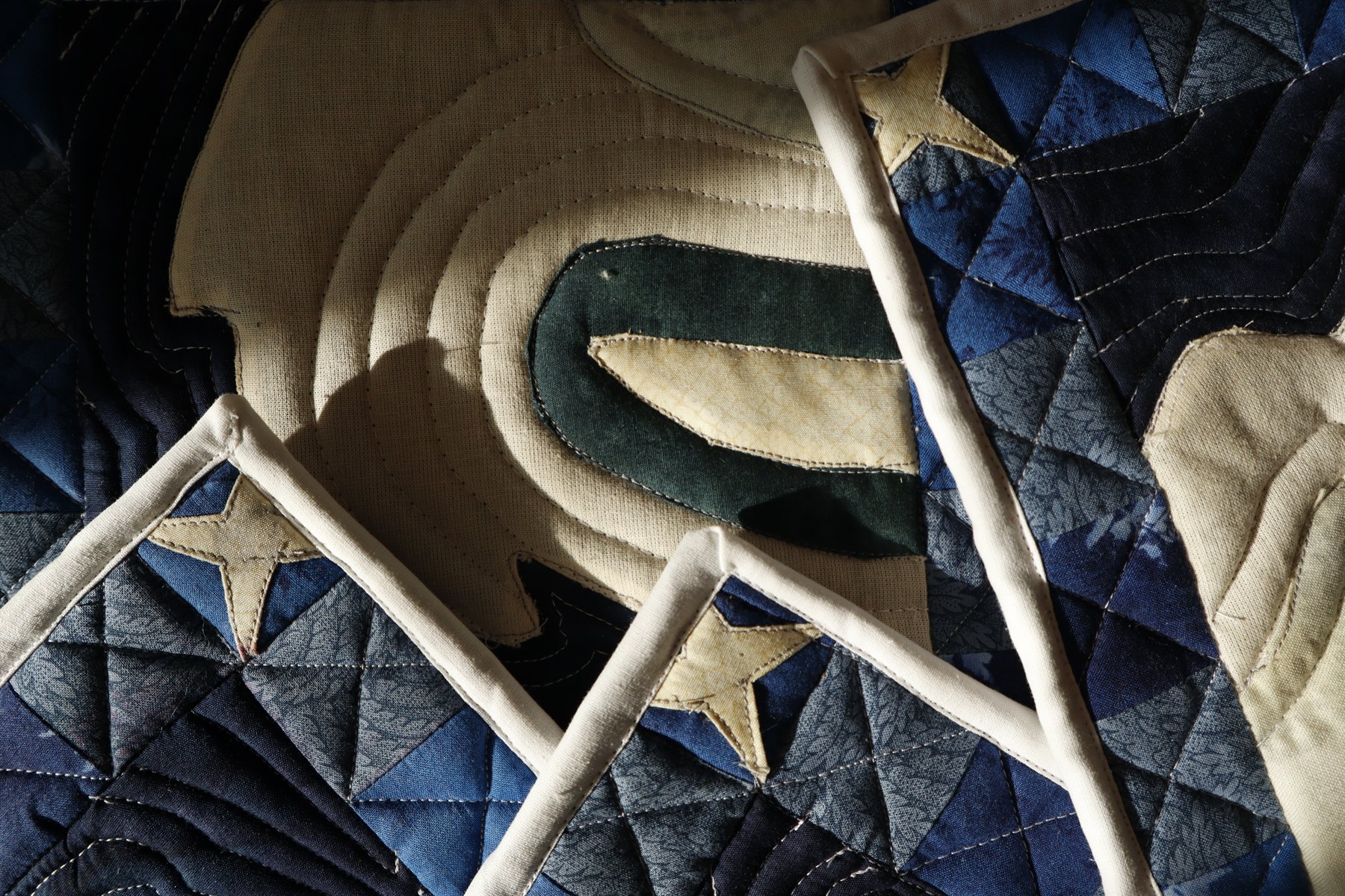 Close-up of quilted swan potholders